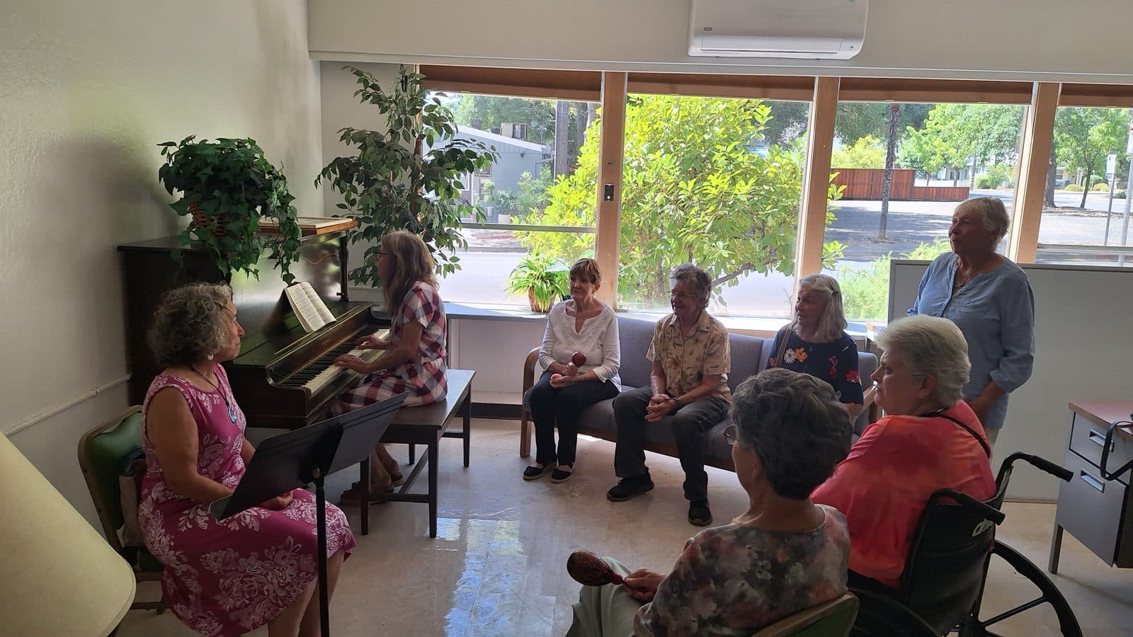 Participants gathered for a music activity in a bright, welcoming room at the Be Well Center